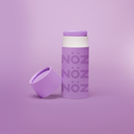 Load image into Gallery viewer, close up of the purple Noz face sunscreen stick with the cap off of it, all in front of a purple background
