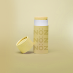 Load image into Gallery viewer, close up of the yellow Noz face sunscreen stick with the cap off of it, all in front of a yellow background
